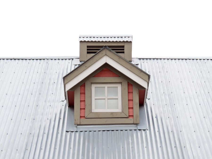Architectural detail of small dormer window in metal sheet roof of residential house